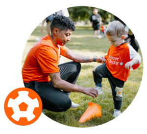 Coach and child on field