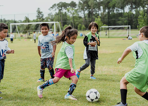 Kids playing soccer with US Soccer Foundation