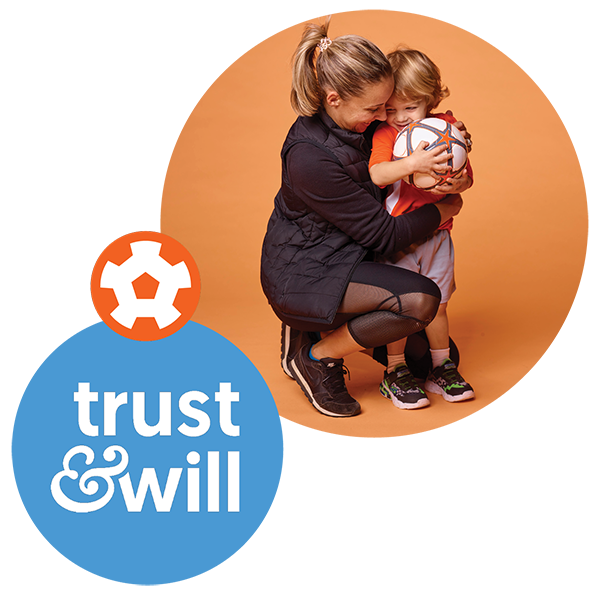 Trust and will logo and image of parent/guardian with young boy and soccer ball